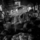 A hawker in the butcher section of Empress Market waves flies off his meat. Many of the traders inside Empress Market fear gentrification could eventually force them out as well.